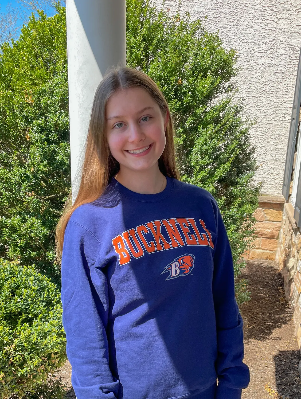 Scarlet standing outside wearing a Bucknell University sweatshirt
