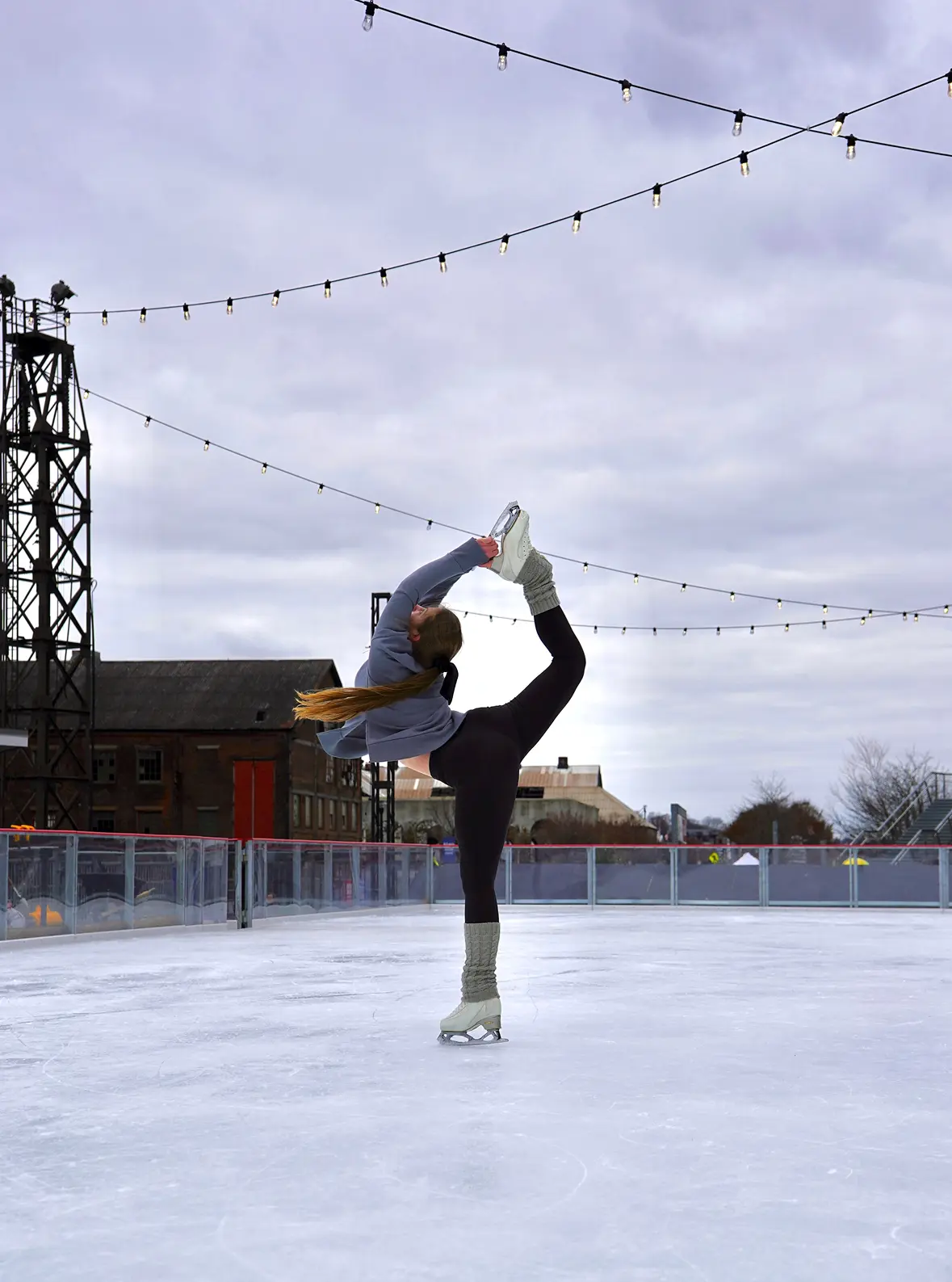 Scarlet performing a figure skating spin at an outdoor ice rink