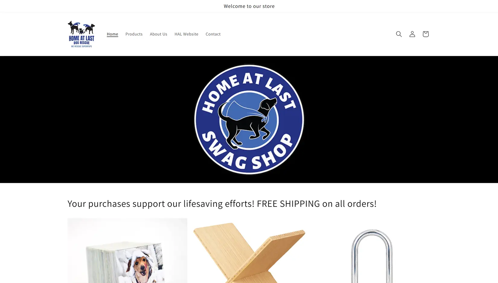 Home At Last Swag Shop storefront with a black promotional banner and product photos for tote bags, wooden decor, and dog leashes